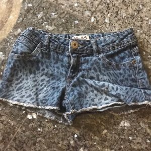 1 pair of faded cheetah print blue jean shorts.